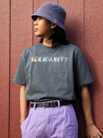 Solidarity Love Tee. Dark gray 100% cotton t-shirt with graphic design.