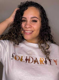 Solidarity One Tee. White 100% cotton t-shirt with graphic design.